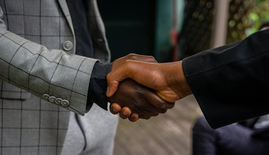 Close-up of two professionals shaking hands, symbolizing success and partnership.